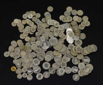 Coins "Frank" of different denominations. The total amount is 157 francs.